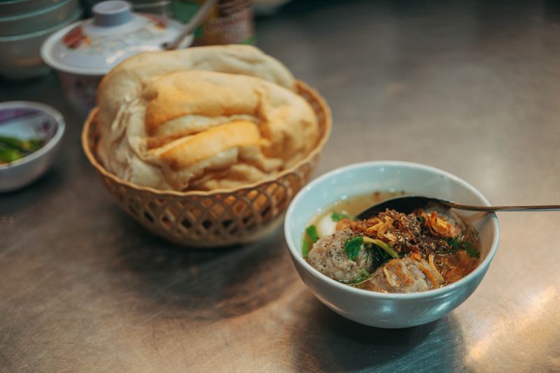 Classic chicken soup with crusty bread roll