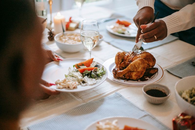 Family feast with whole chicken, fries and sides
